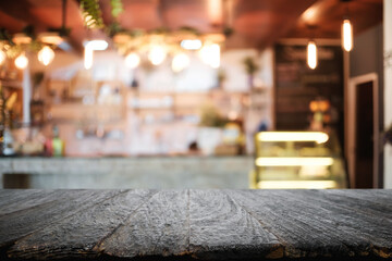 Obraz na płótnie Canvas Empty wooden table space platform and blurred resturant or coffee shop background for product display montage.