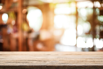 Empty wooden table space platform and blurred resturant or coffee shop background for product display montage.