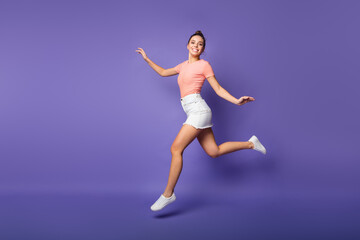 Fototapeta na wymiar Full body photo of pretty cute lovely girl jump run copyspace enjoy spring discount motion wear good look outfit footwear isolated over purple color background
