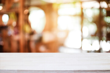 Empty wooden table space platform and blurred resturant or coffee shop background for product display montage.