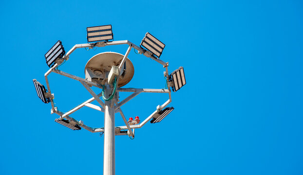 Stadium Lighting Mast Against Blue Sky