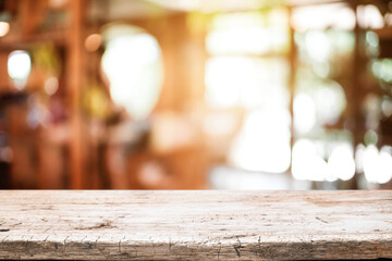 Empty wooden table space platform and blurred resturant or coffee shop background for product display montage.