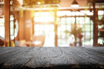 Obraz na płótnie Canvas Empty wooden table space platform and blurred restaurant or coffee shop background for product display montage.