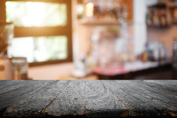 Empty wooden table space platform and blurred restaurant or coffee shop background for product display montage.
