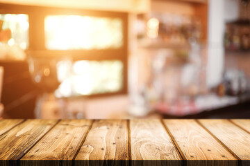 Empty wooden table space platform and blurred restaurant or coffee shop background for product display montage.