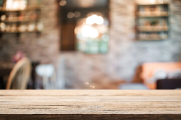 Empty wooden table space platform and blurred restaurant or coffee shop background for product display montage.