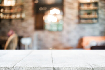 Empty wooden table space platform and blurred resturant or coffee shop background for product display montage.