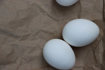 White eggs on brown background, healthy food