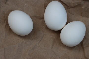 White eggs on brown background, healthy food
