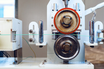 Inside a modern plant producing power electric cables and optical fibers. .Cable manufacturing machine part.