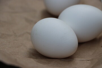 White eggs on brown background, healthy food