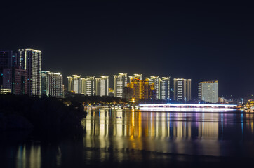 Obraz premium Night panorama view of Sanya city on Hainan island, China