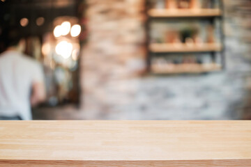 Empty wooden table space platform and blurred resturant or coffee shop background for product display montage.