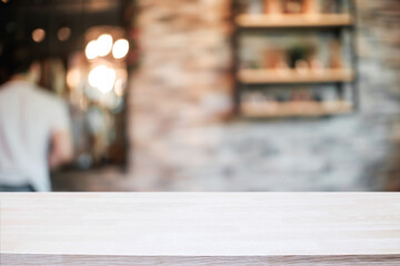 Empty wooden table space platform and blurred resturant or coffee shop background for product display montage.