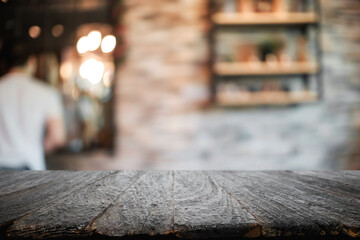 Empty wooden table space platform and blurred resturant or coffee shop background for product display montage.