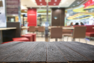 Empty wooden table space platform and blurred resturant or coffee shop background for product display montage.