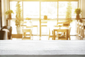Empty wooden table space platform and blurred resturant or coffee shop background for product display montage.