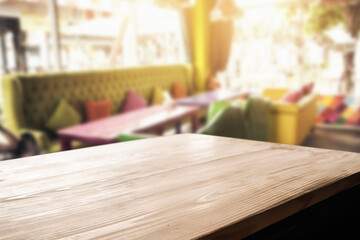 Empty wooden table space platform and blurred resturant or coffee shop background for product display montage.