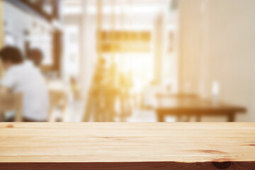 Empty wooden table space platform and blurred resturant or coffee shop background for product display montage.