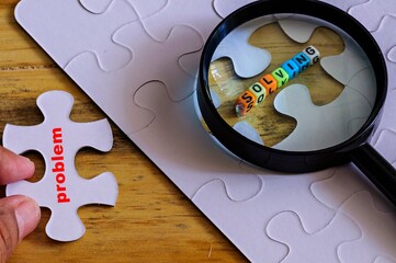 conceptual of problem solving. Finger holding loose piece with text 