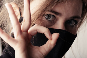 face of sad young woman in a black stylish mask, fashion and life 2020 under quarantine and...