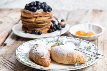 Croissants on a white plate with green ornament