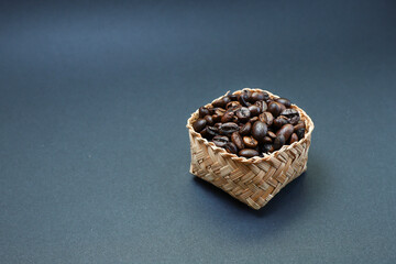 Coffee beans in a bucket on black background 