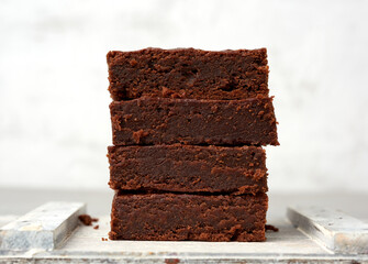stack of square baked brownie chocolate cake slices