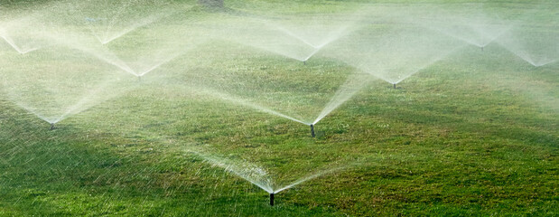 water splashes from automatic watering the lawn