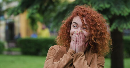 Close up of Woman face, laughs surprised covering her face with her hands, Attractive Ginger...