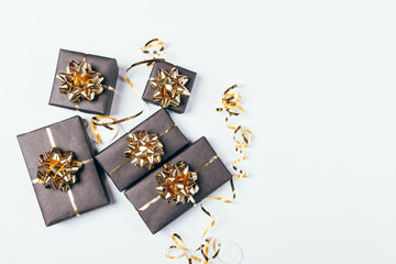 Festive black gift boxes with golden bows and ribbons