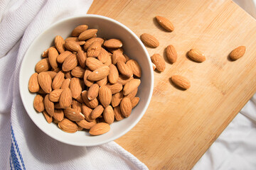 bowl of almonds on a wooden table background