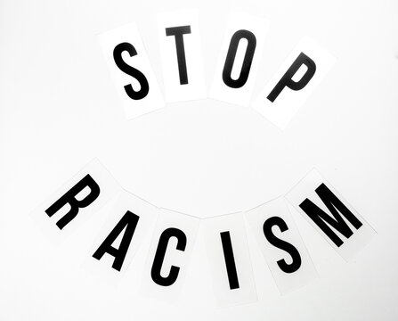 Light box with the text "stop racism" against black and white background
