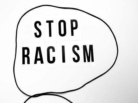 Capital letters with the text stop racism against white background
