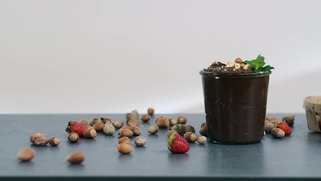 Hazelnuts rolls on the table on the backgroound. Heathy chocolate dessert with nuts