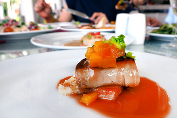 fois gras in mango mixed fruit sauce served on white plate dish in restaurant environment © Artorn