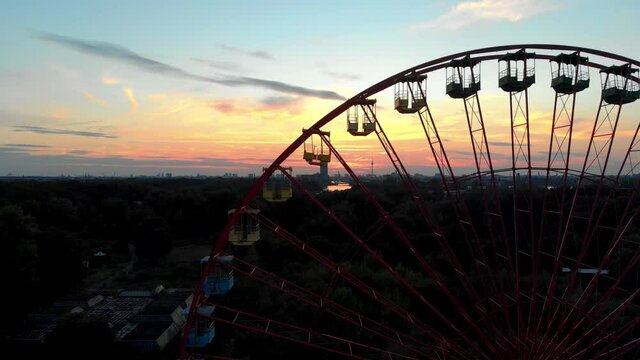Silhouette of Ferris Wheel in Abandoned Amusement Park, Drone Aerial View of Berlin Sunset Skyline From Spreepark