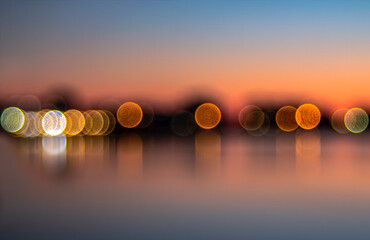Abstraction. Play with the lights of the buildings reflected in the lake after sunset.