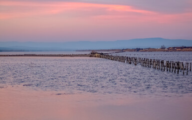 A series of landscapes of a salt lake in a seaside resort. Gentle pink shades of sunset. Pomorie resort, Bulgaria.