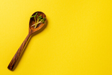 Micro greens in wooden spoon on paper background
