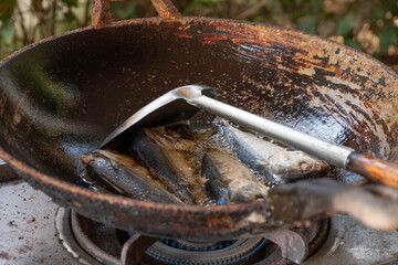 Mackerel fried in an old pan
