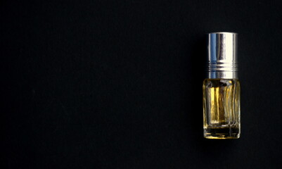 Dhaka, Bangladesh-April 28, 2020: A bottle of Attar and classical earring. Attar is a natural perfume oil, delivered from botanic sources. Use of it highly encouraged in Islam