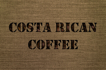 Costa Rican coffee varieties text made up of coffee beans on a background of canvas fabric