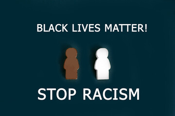Black and white figures of people on a black background. The inscription in chalk-Stop racism....