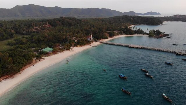 Aerial view, flying over the sea. Fishermen boats mouring closed to a pier. Drone dji mavic air 4K 30fps