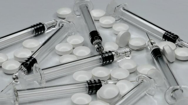 Rotating Of Syringes and Medical Pills and Drugs Close-up .