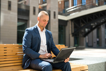 handsome young man in suit with laptop