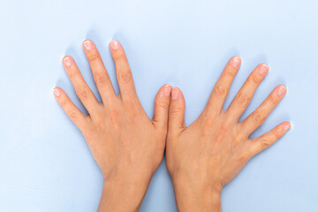 woman hands isolated on light blue background 

