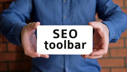 Seo toolbar - seo concept in the hands of a young man in a blue shirt