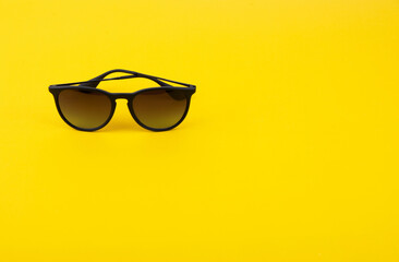 Stylish Sunglasses on Bright Yellow Background